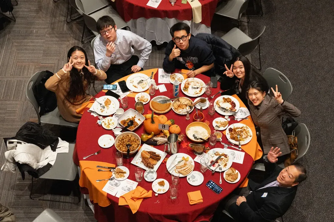 Students at a table eating dinner.