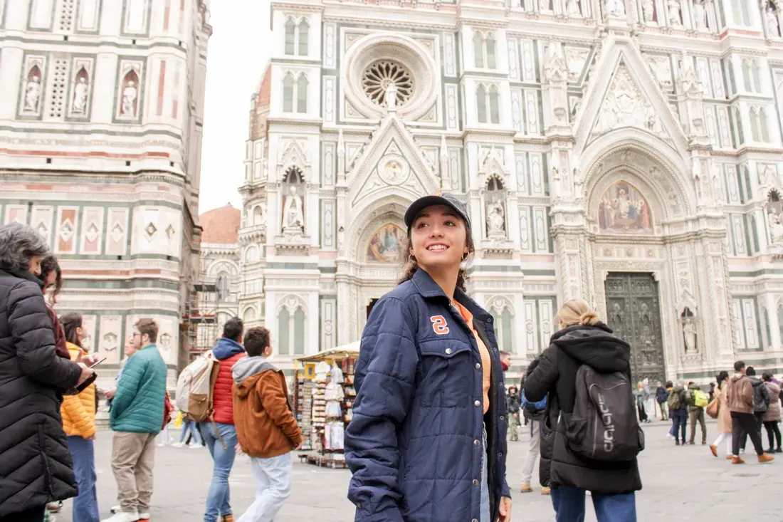 Person in front of the Duomo in Florence.