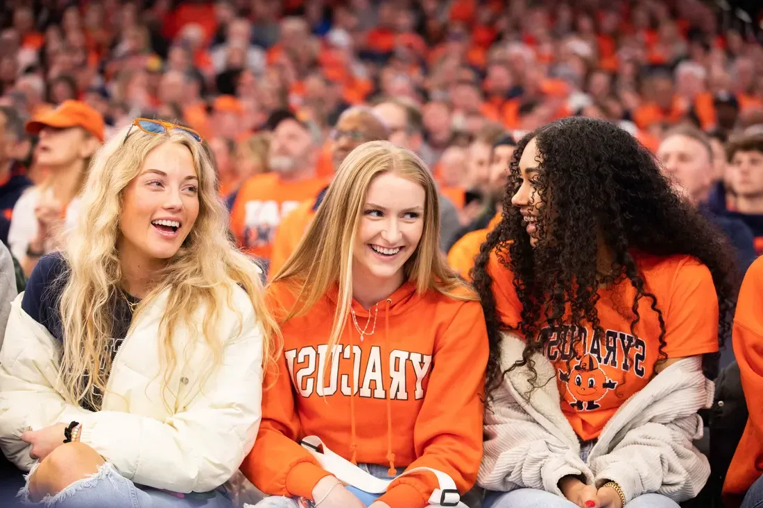 Three students at game in the dome.