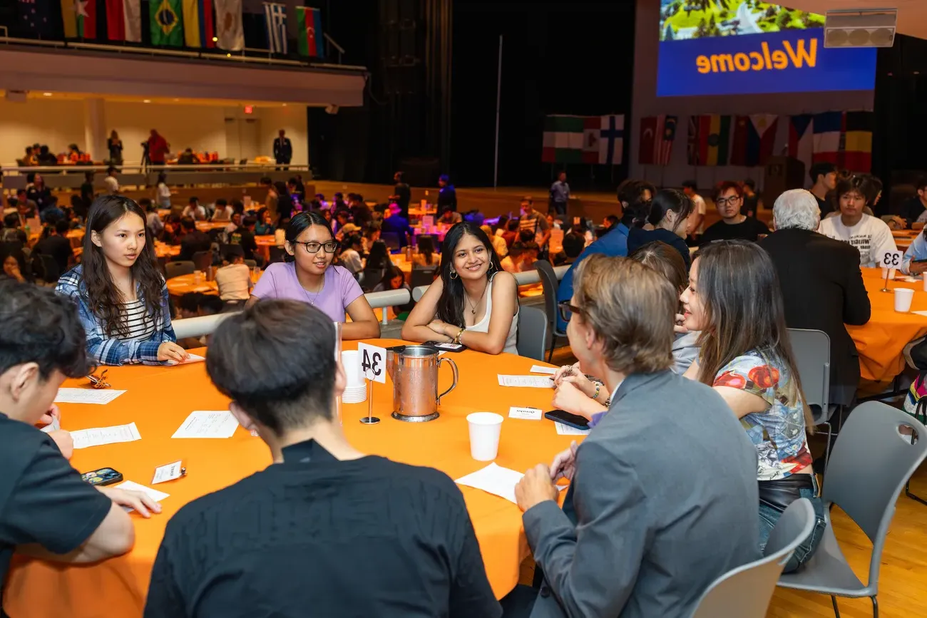 Students sitting at a table at the International Students Welcome dinner.