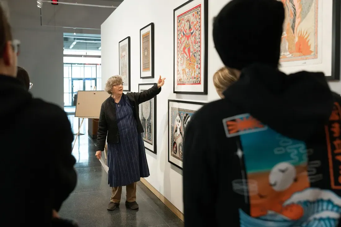 Professor shows art to students.